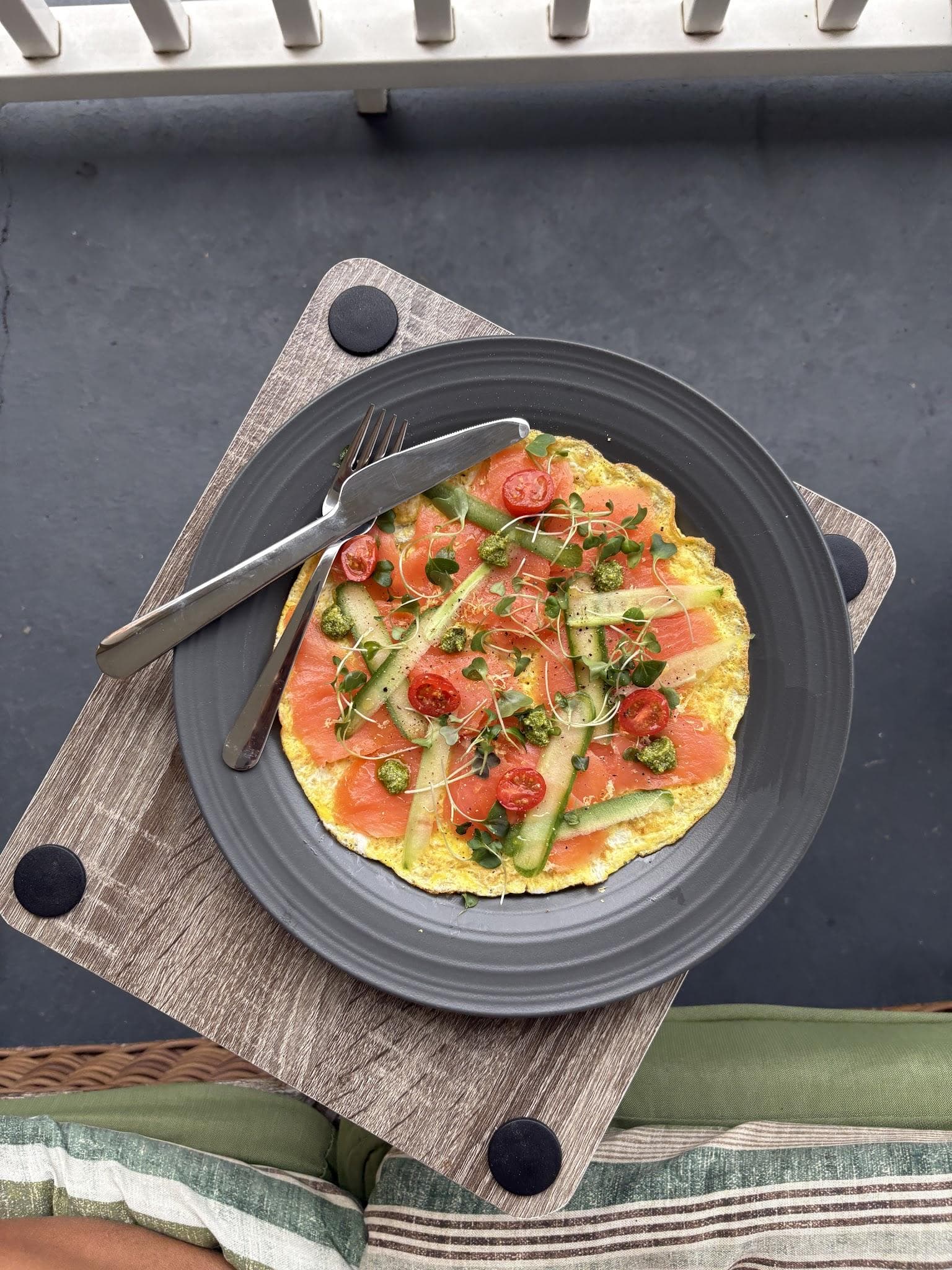 An open-faced egg dish with avocado and tomatoes